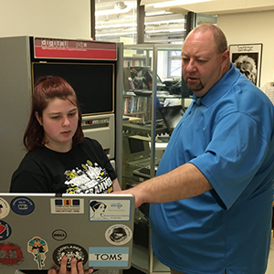 Dr. Mike Littman (right) helps a student during the 4th annual hackathon.