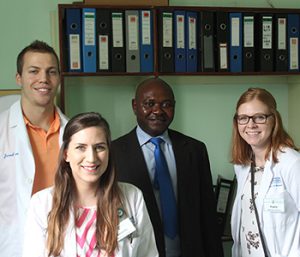 Jared Gillingham, Amanda Bartosik, and Taylor Poulsen with the clinical pharmacist of the Zambia oncology department.