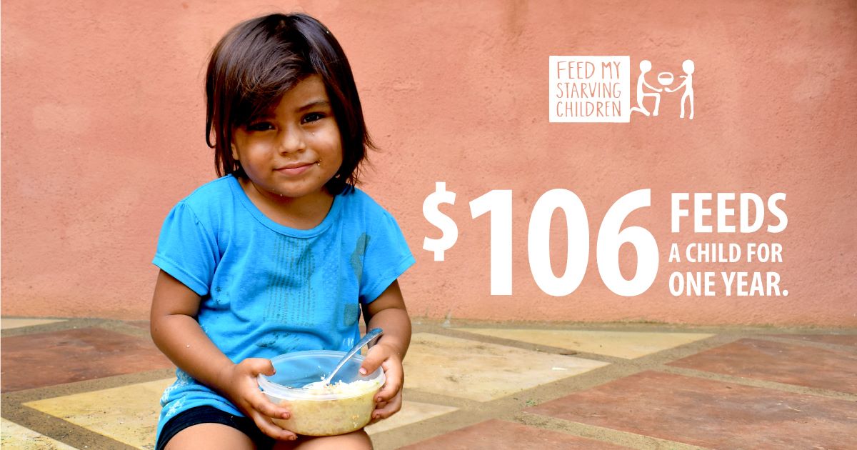 girl with blue shirt holding food bowl