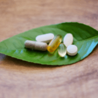 herbal supplements on a green leaf