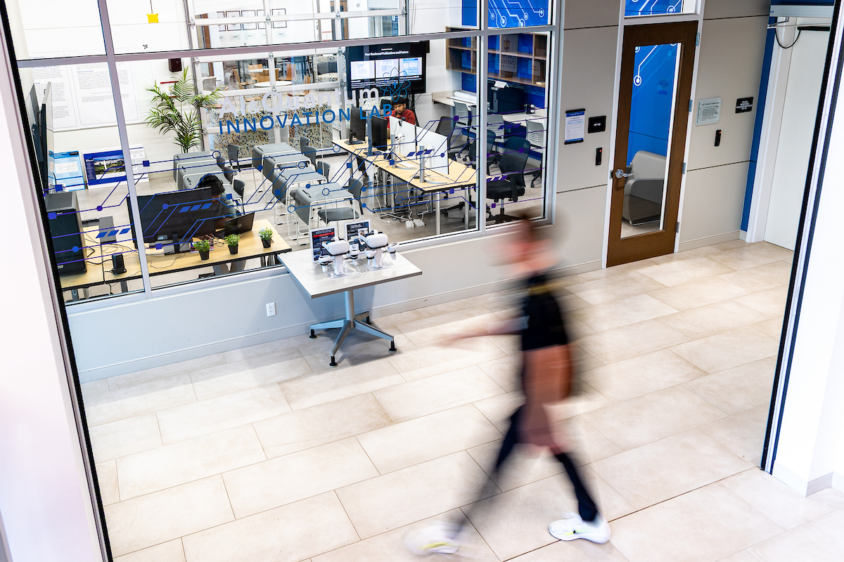 student walking by AI lab