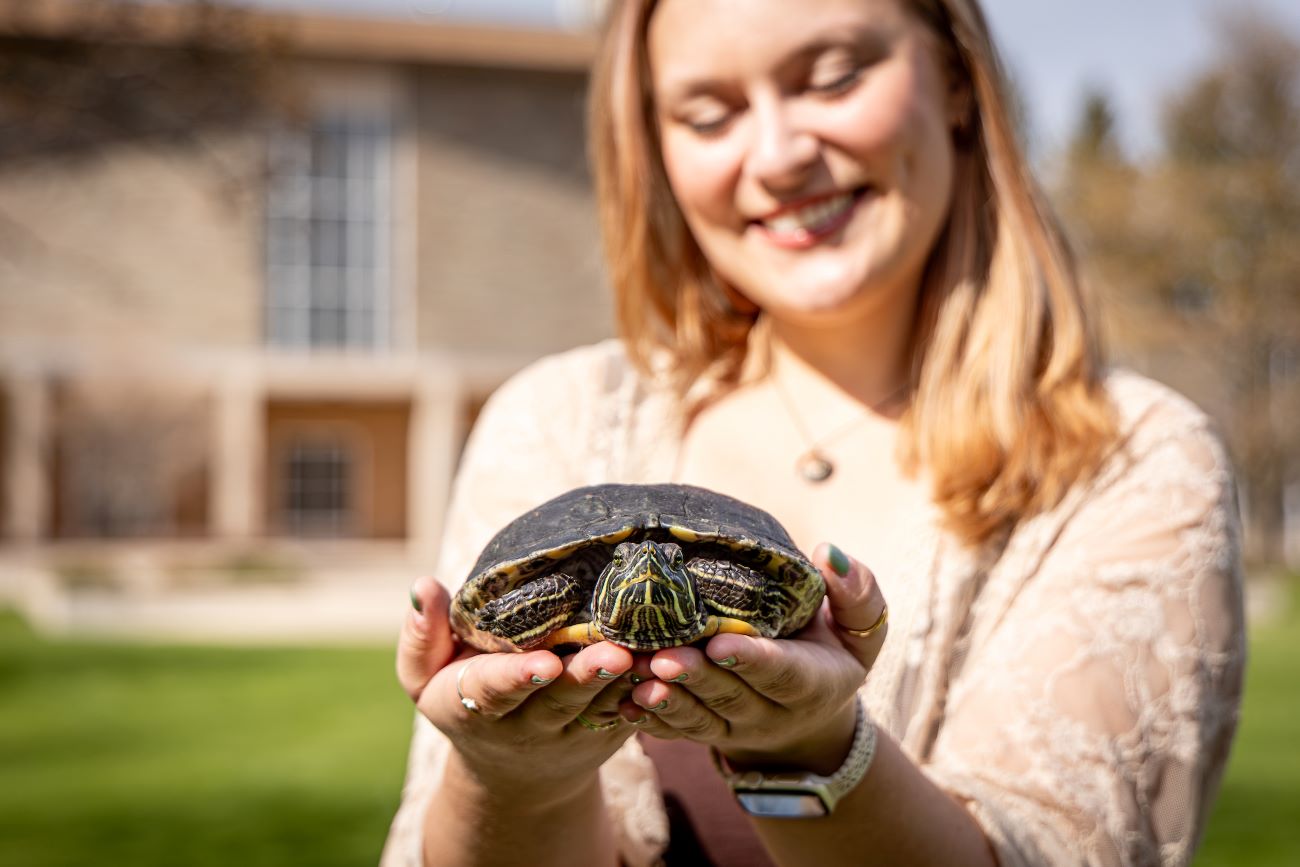 student holding turtle