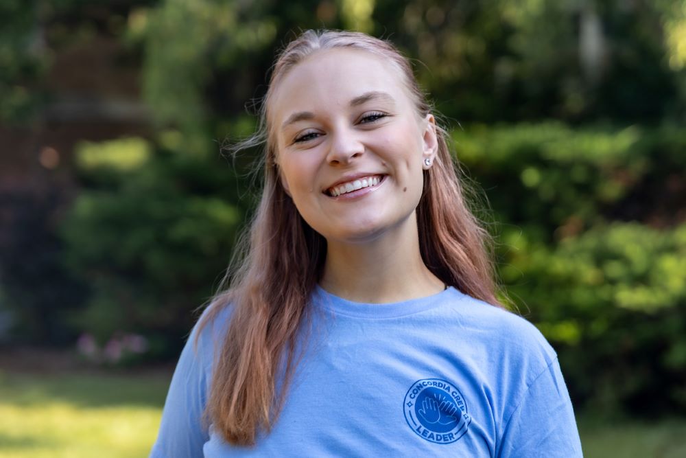girl with blue shirt and blonde hair