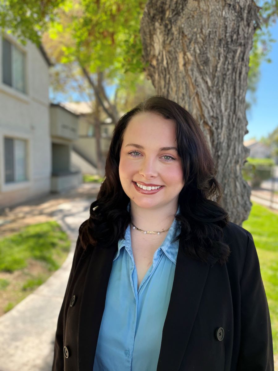 woman in front of tree smiling