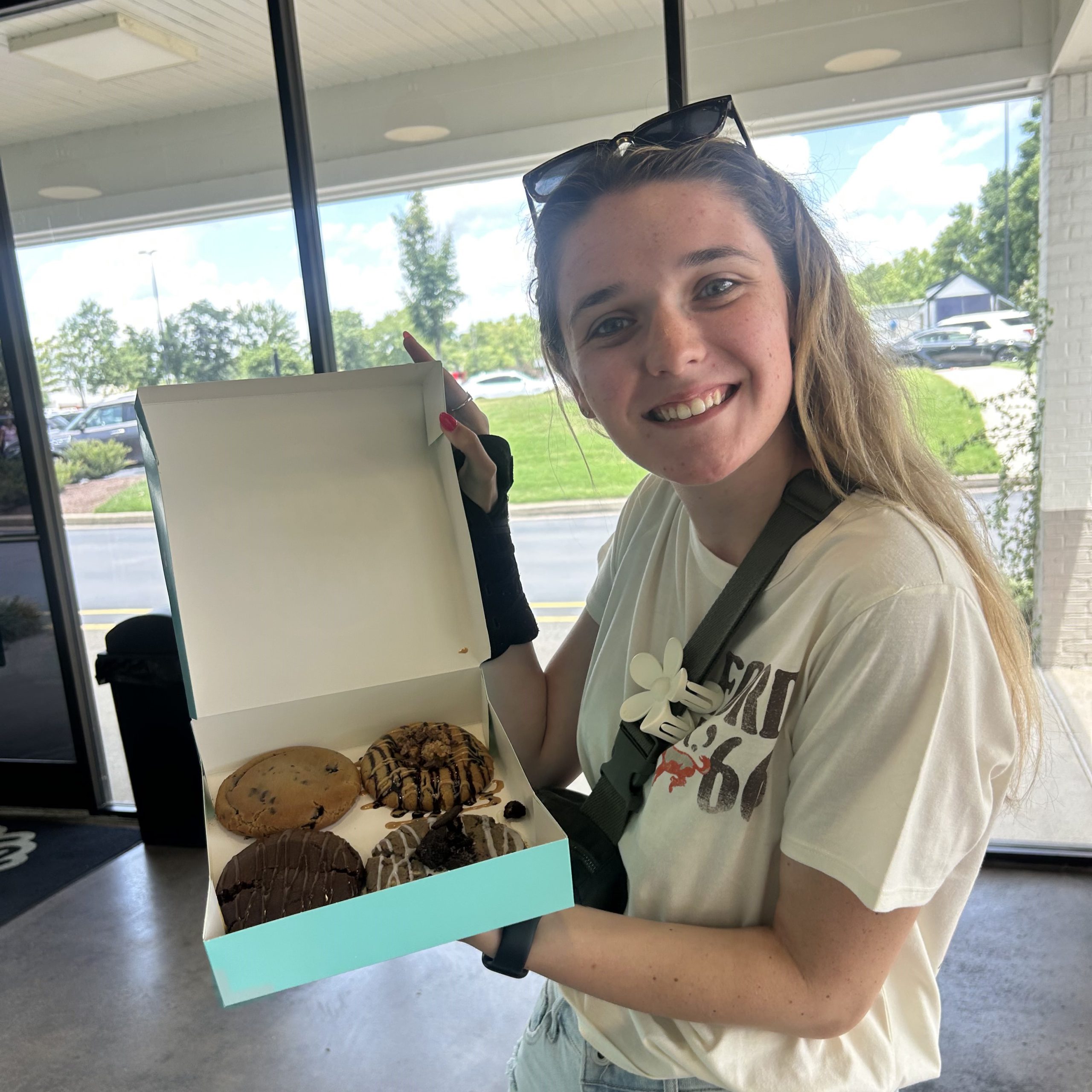girl holding donuts
