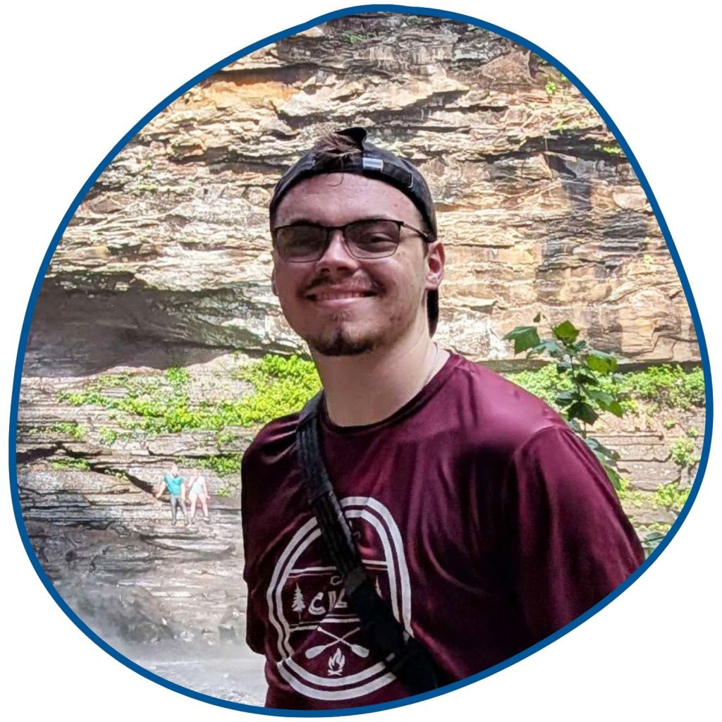 man with burgundy shirt and glasses