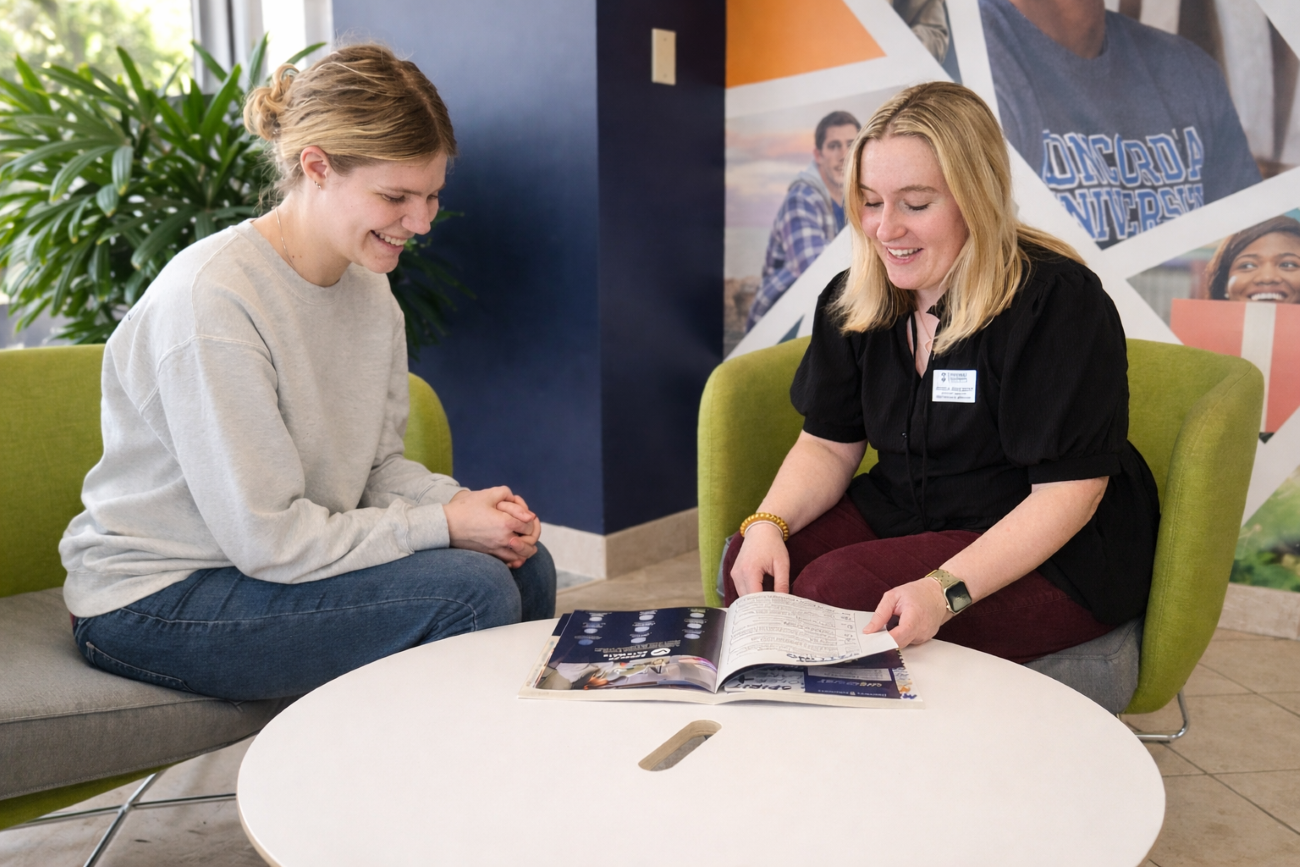student and admissions counselor at table