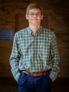 man with glasses and green checkered shirt