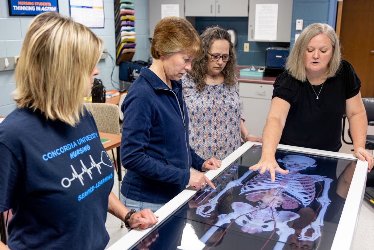 woman looking at table with human skeleton