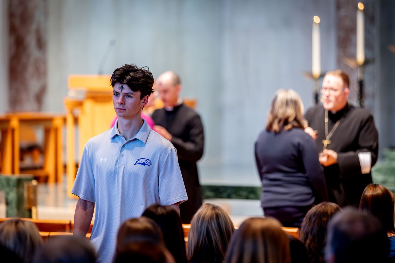 student with ashes on head in church