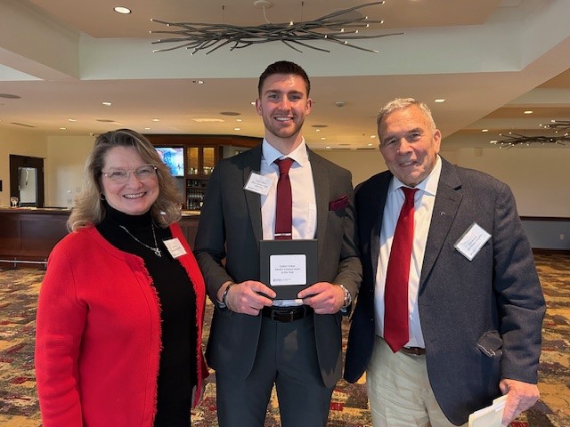 man with award and parents