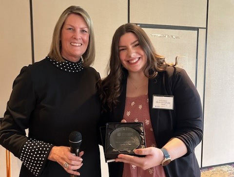 woman with girl and award