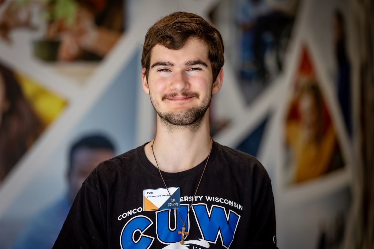 man with dark hair and smirking