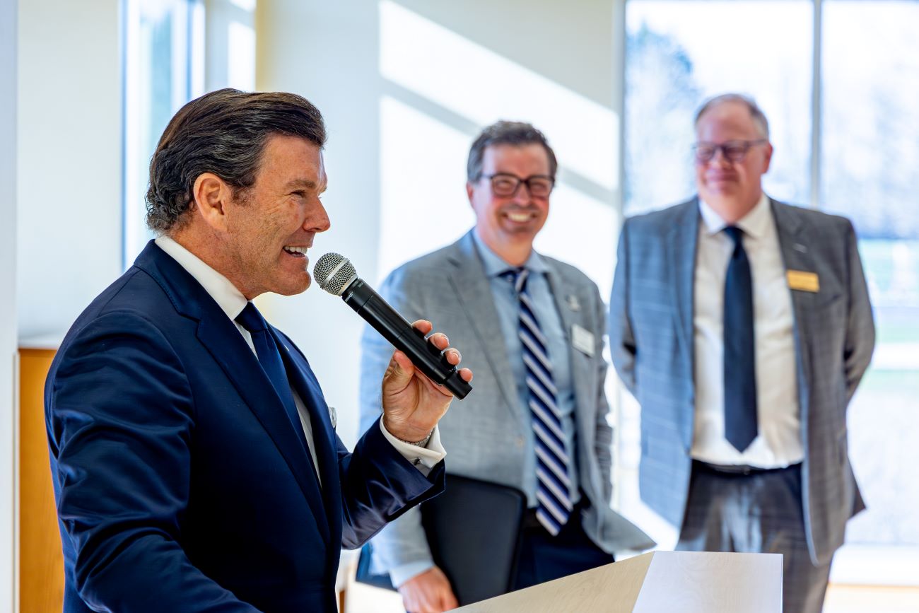 man talking into microphone at event