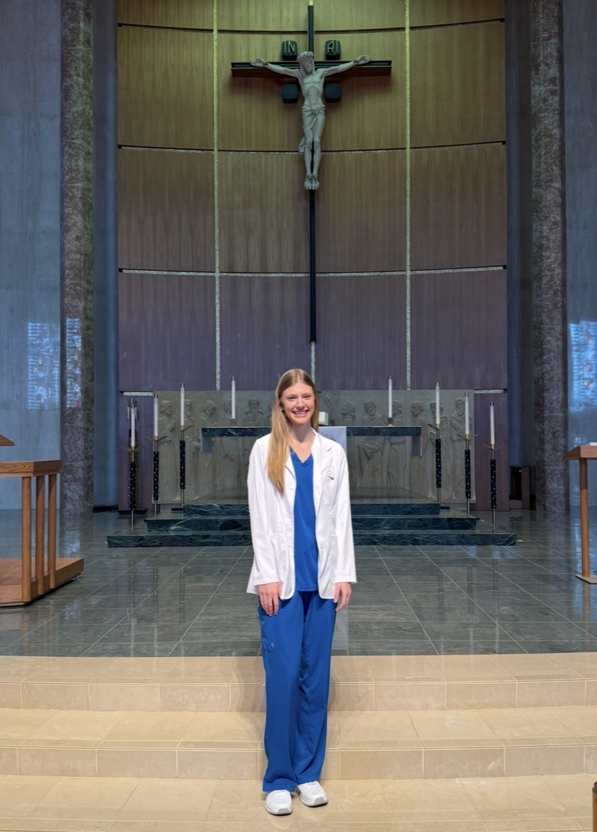 woman in scrubs in chapel