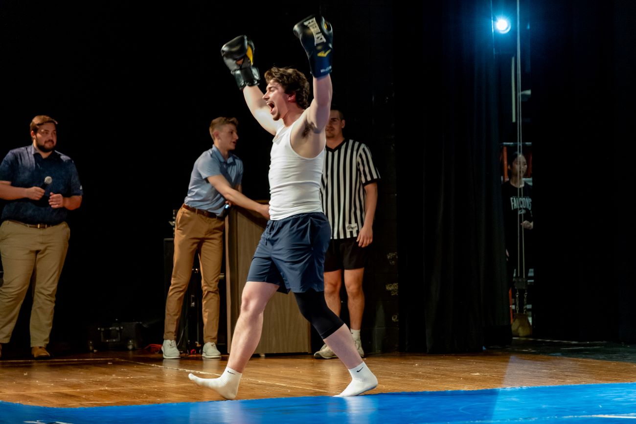 man with gloves on cheering
