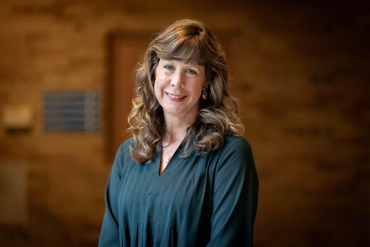 woman with brown hair and black top