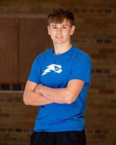 boy in blue with arms crossed