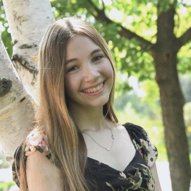 girl with long hair by a tree