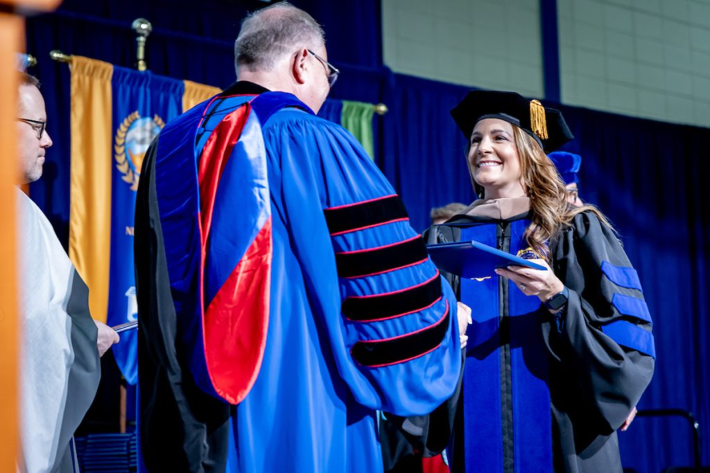 woman receiving diploma