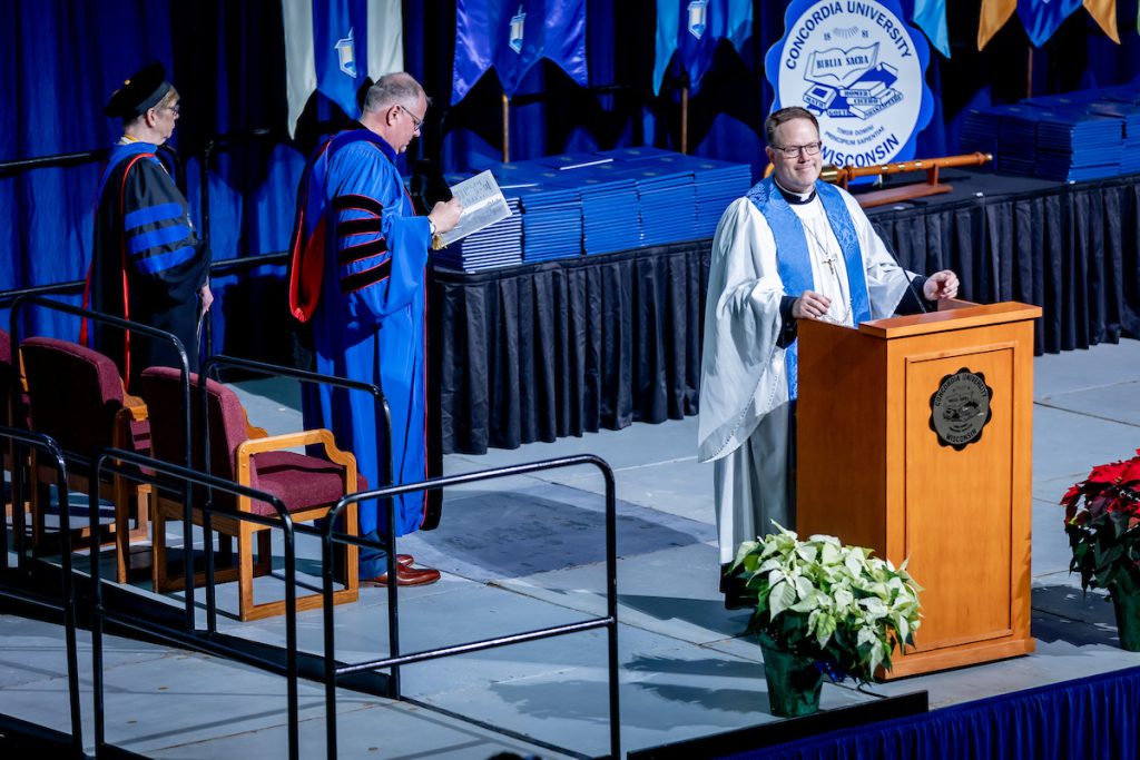 pastor on commencement stage