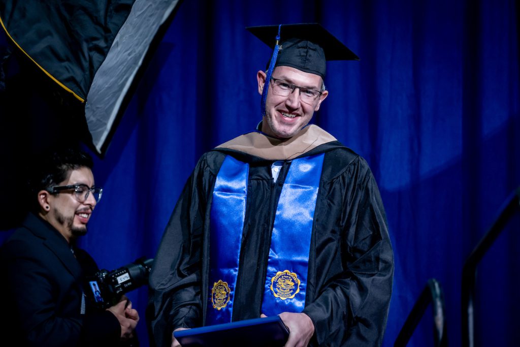 guy with glasses and diploma