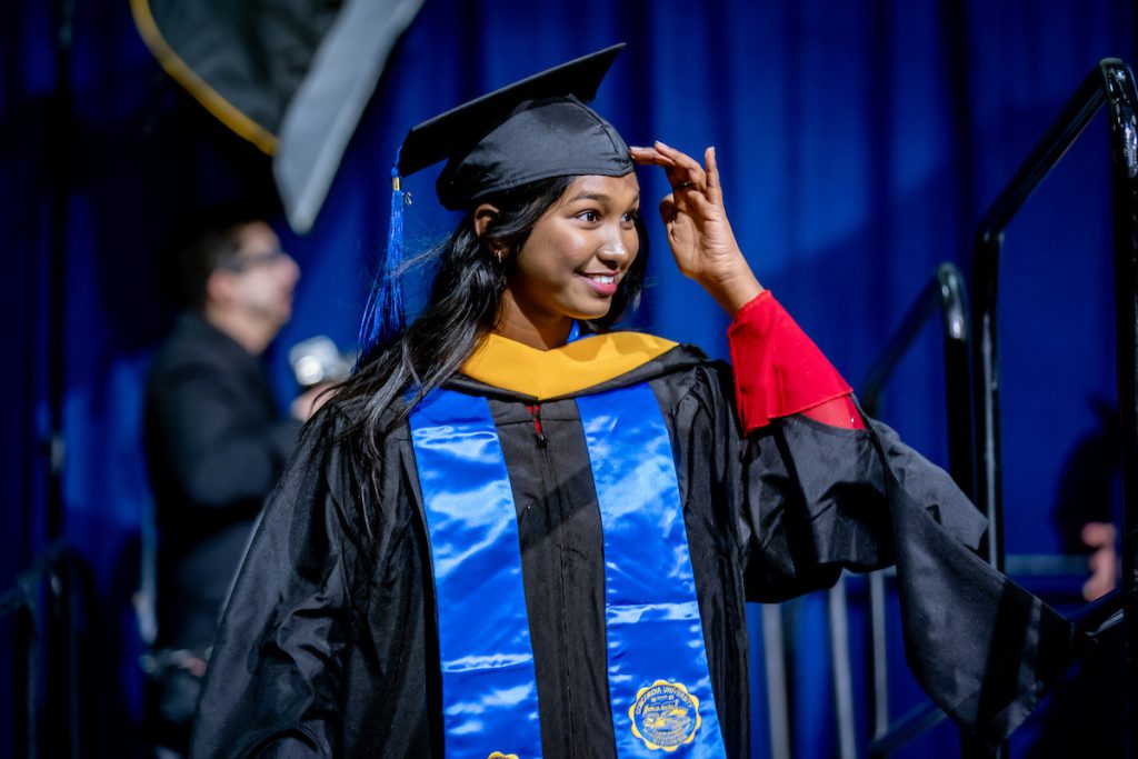 graduate smiling and moving tassel