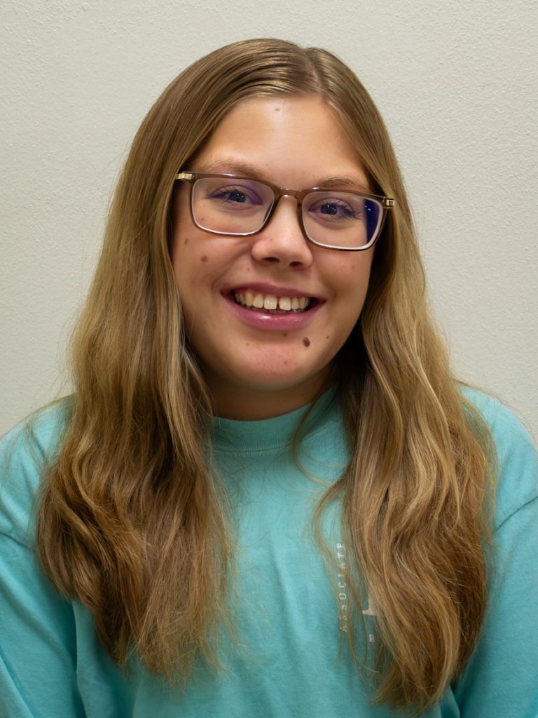 girl with brown hair and glasses