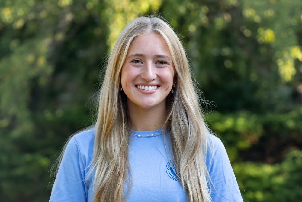 girl with blonde hair and blue shirt