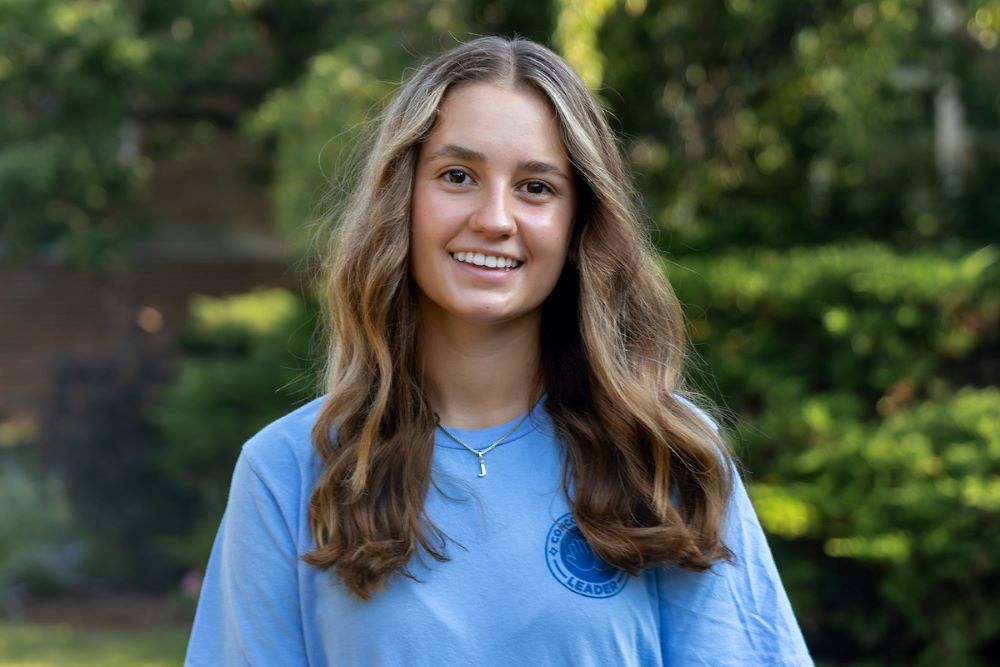 girl with long brown and blonde hair with blue shirt