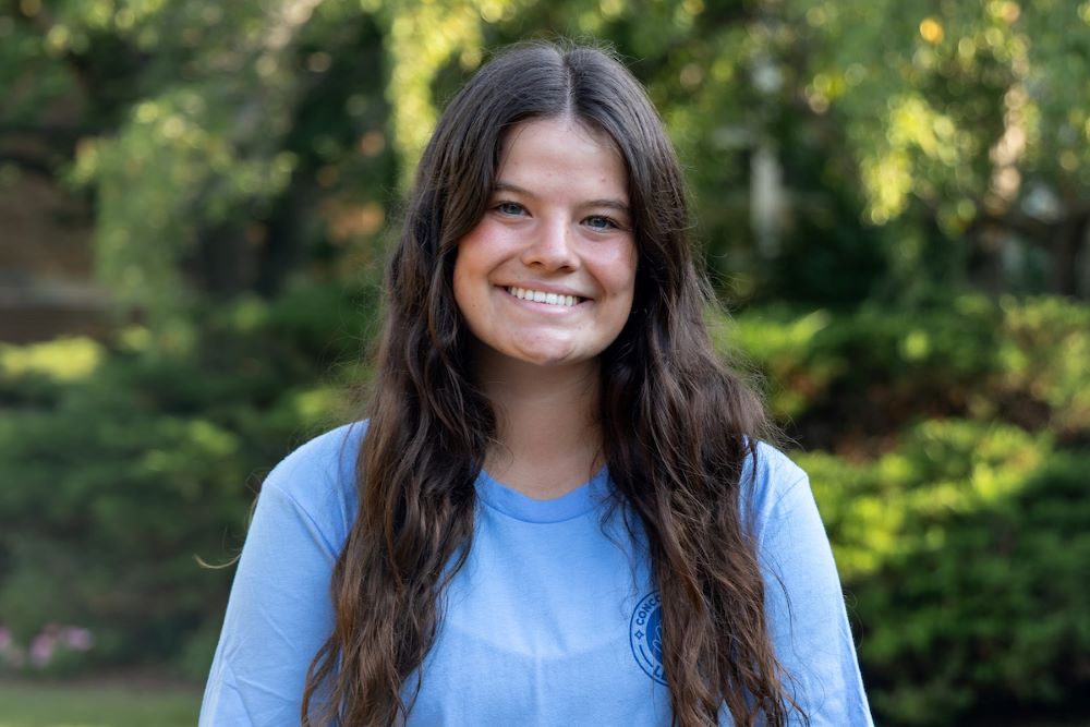girl with long dark hair with blue shirt