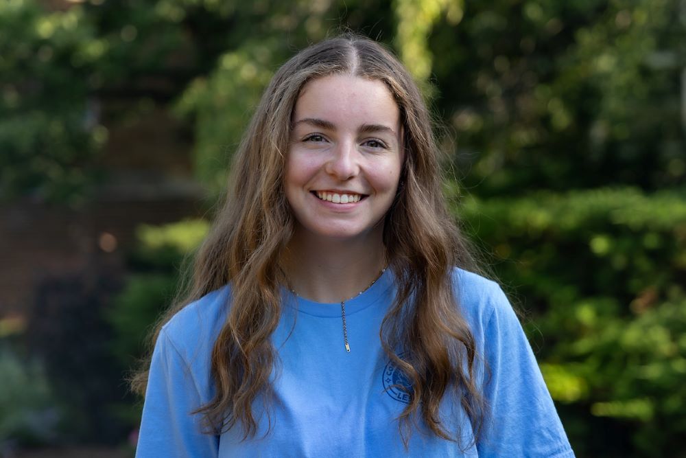 girl with long brown hair and blue shirt