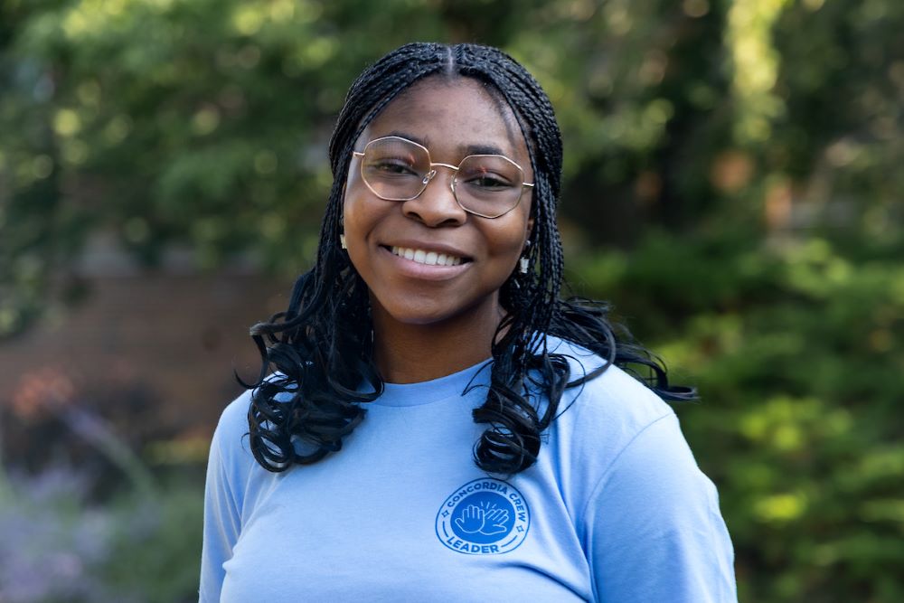 black girl with dark hair and blue shirt