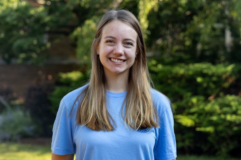 girl with long brown hair and blue shirt