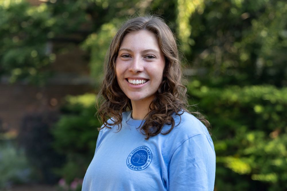 girl with mid-length brown hair and blue shirt