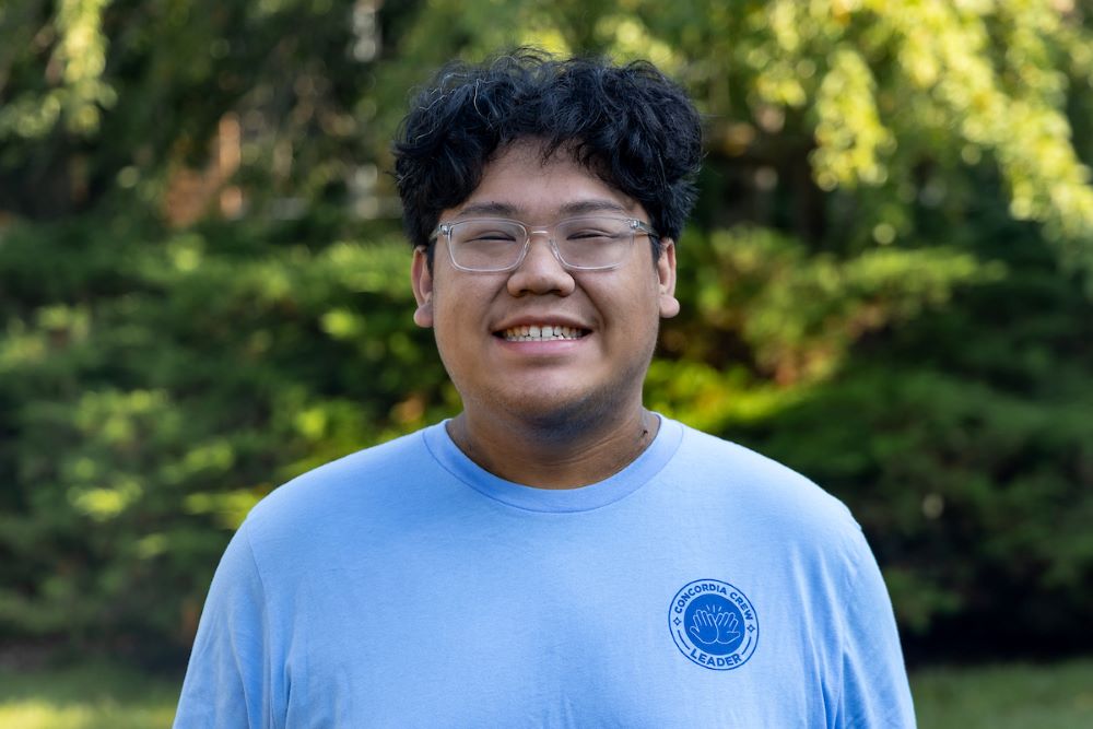 man with dark hair and glasses