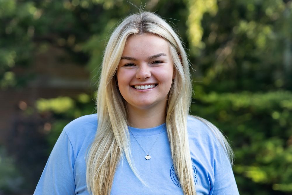girl with long blonde hair and blue shirt