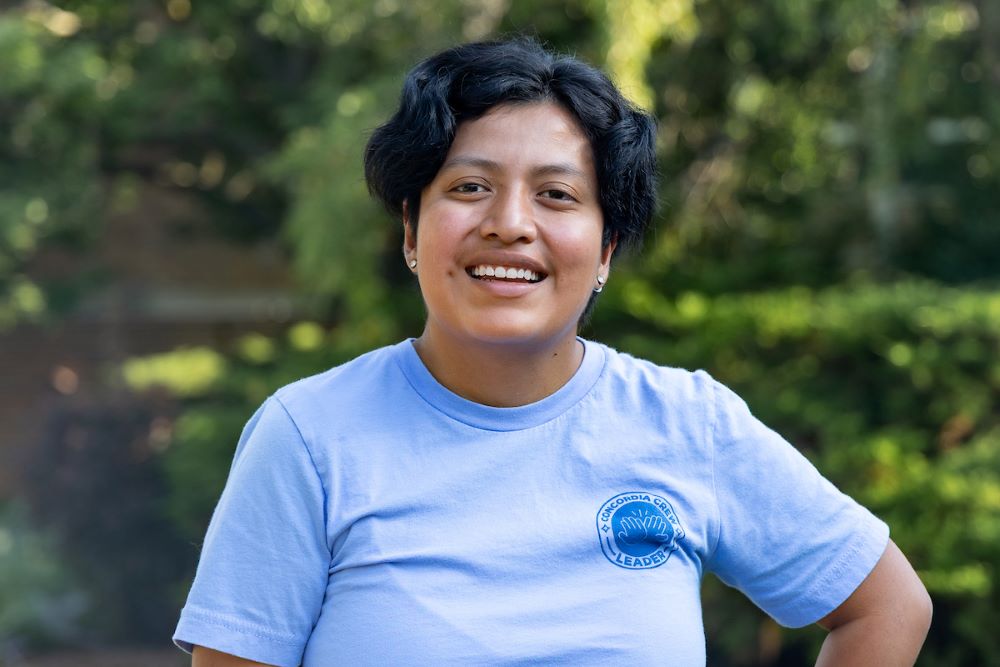 girl with short dark black hair and blue shirt