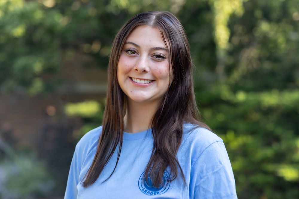 girl with long brown hair and blue shirt