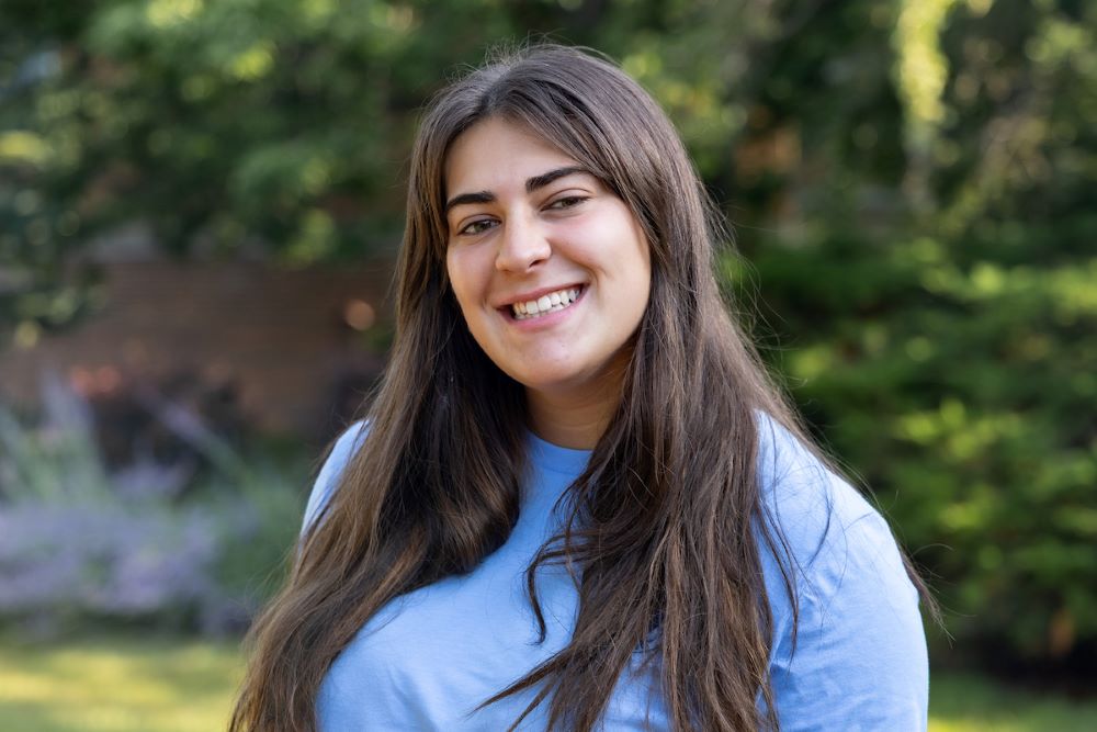 girl with dark hair and blue shirt