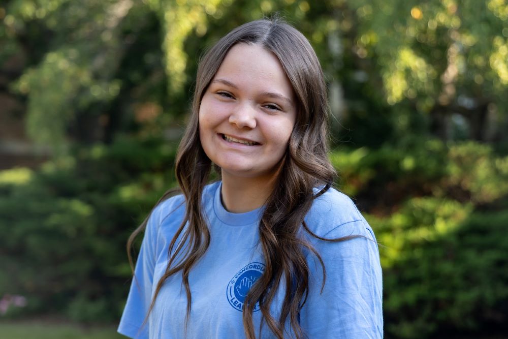 girl with long brown hair and blue shirt