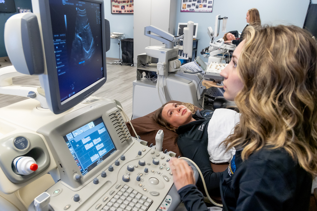 student using ultrasound machine
