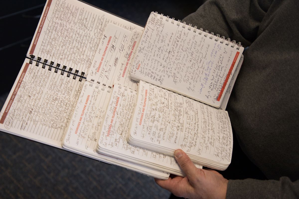 picture of four journals on man's lap