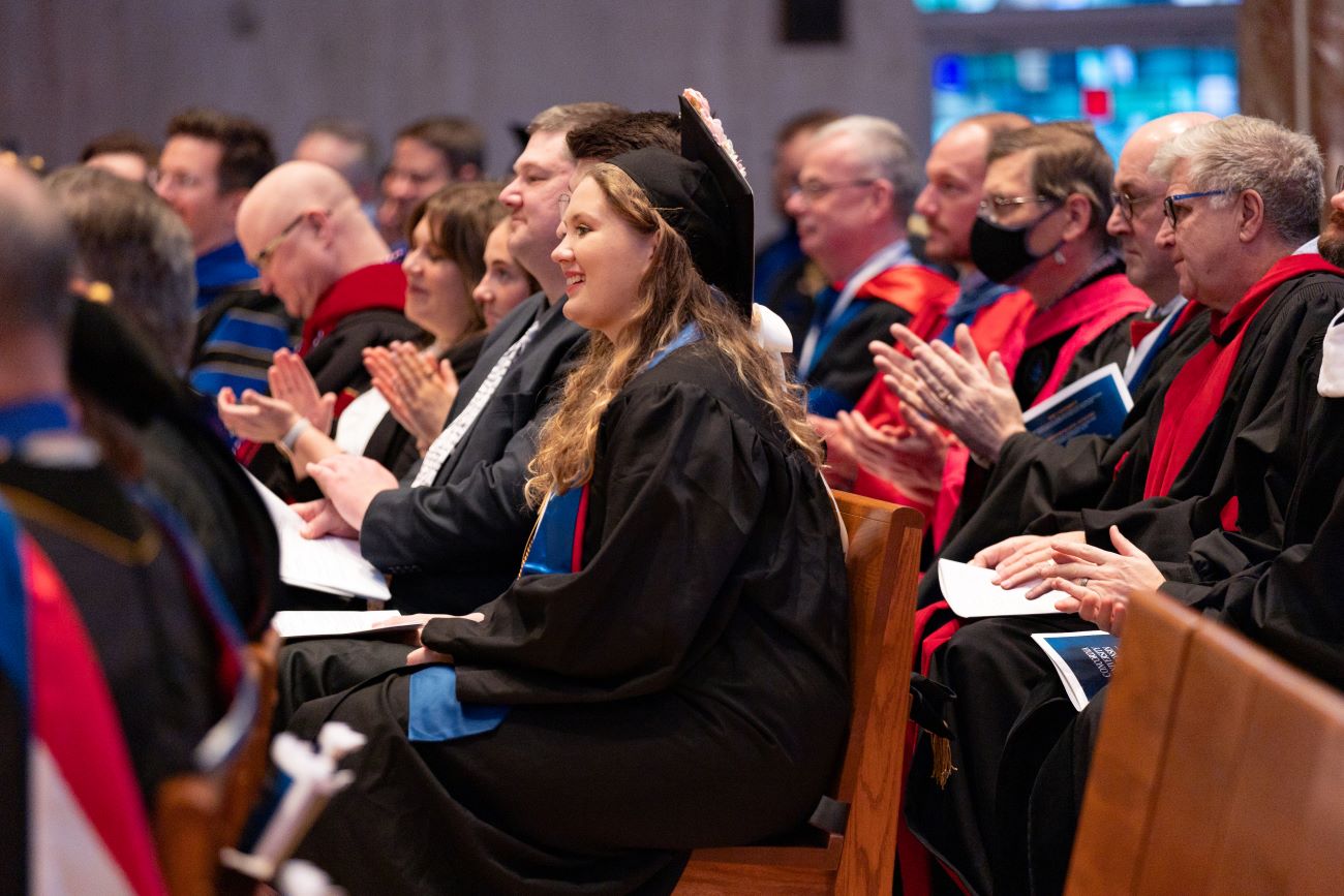 students waiting in seats to graduate