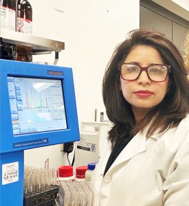 woman in lab coat doing research