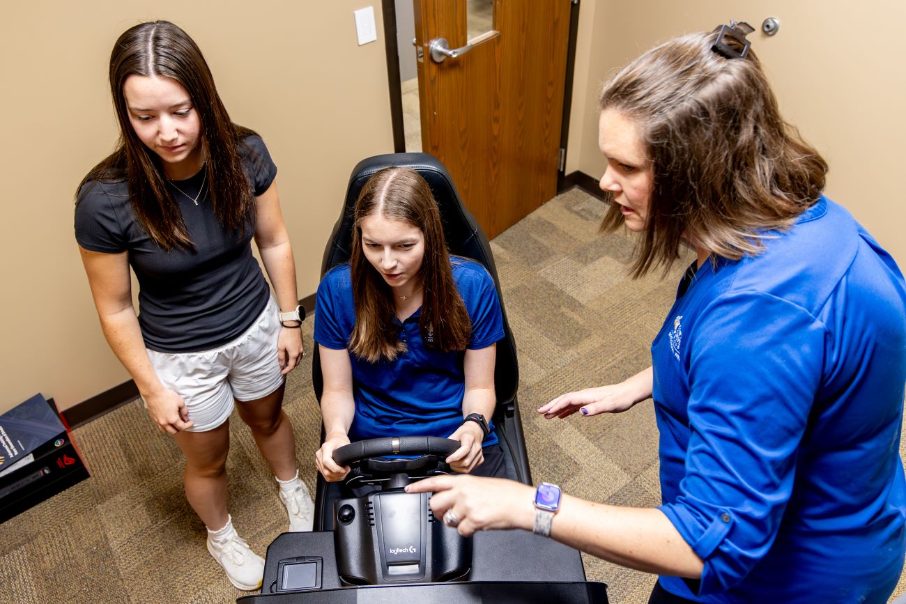 students preparing to use driving sim