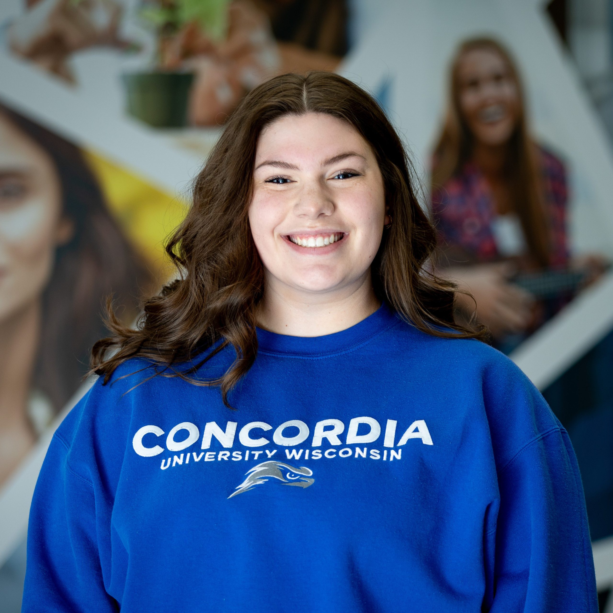 girl with dark hair and blue sweatshirt