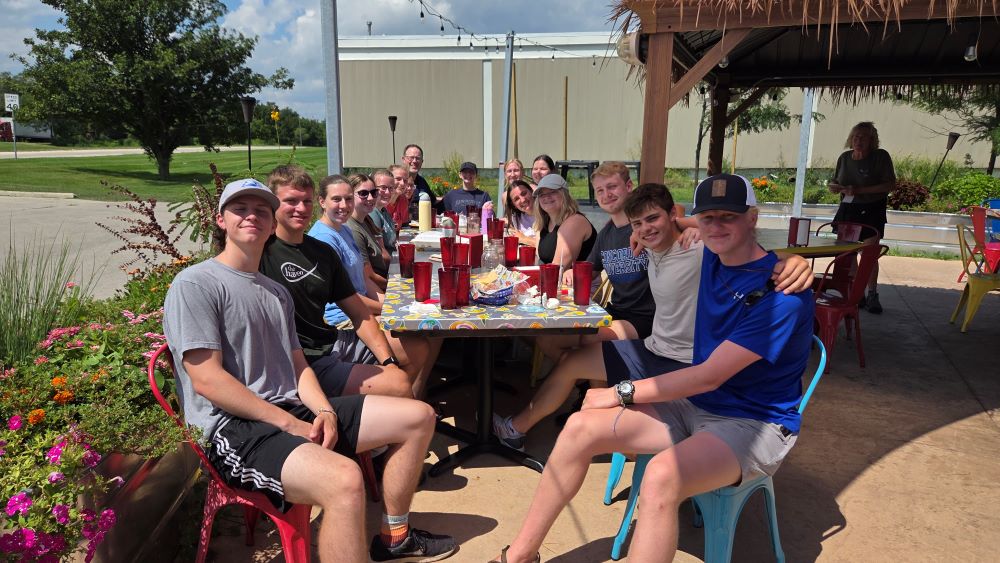 students eating a picnic table