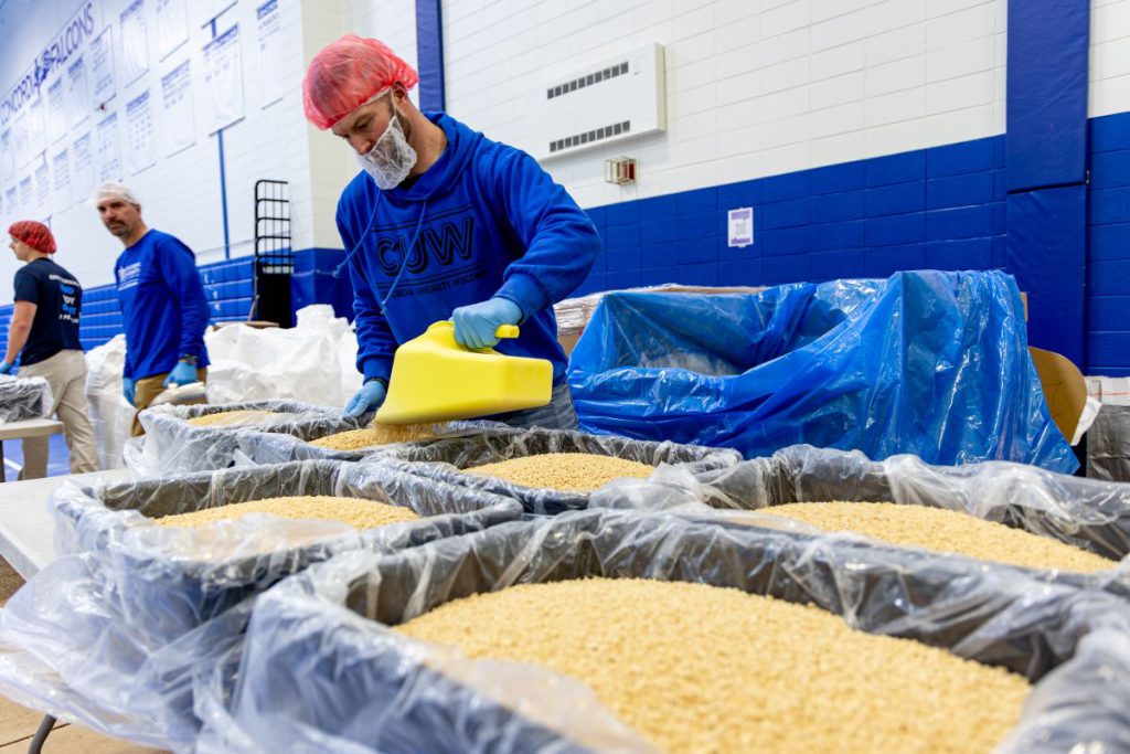 guy pouring food into containers