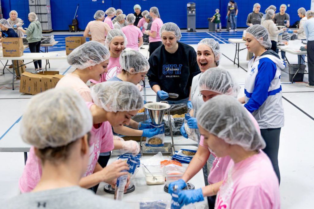 students volunteering to pack meals
